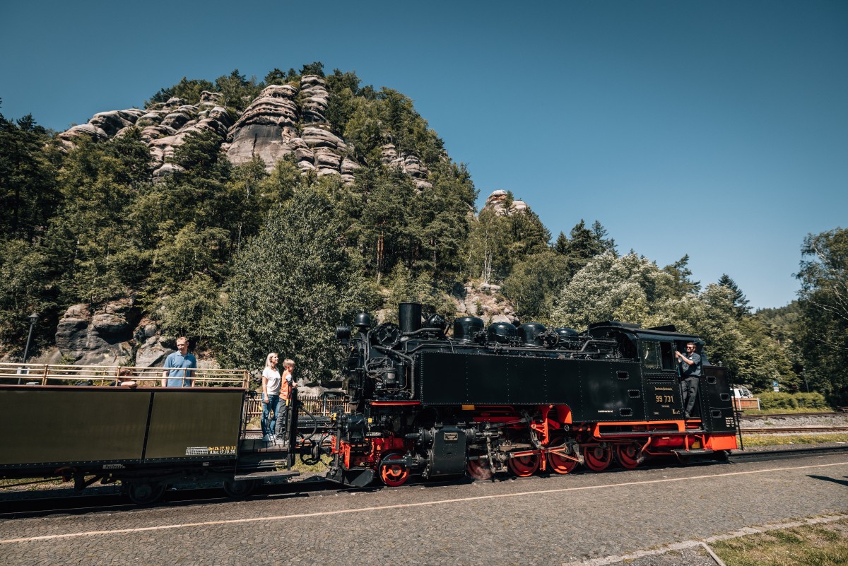 Unterhalb der Berg Oybin mit Burg und Kloster Oybin ist der Bahnhof Kurort Oybin der Zittauer Schmalspurbahn gelegen. In den Sommermonaten lässt sich die Schönheit des Zittauer Gebirges auch vom offenen Aussichtswagen bestaunen. © Philipp Herfort Photography